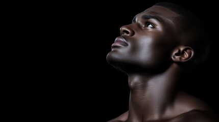 Man gazing upward, profile view, dark background