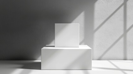 Fototapeta premium A white box is on top of another white box. The boxes are placed in front of a wall