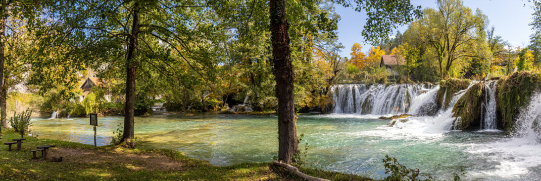 Panoramic photograph of the Rastoke Waterfalls, where the Slunjčica River meets the Korana River, creating a dreamlike landscape. Rastoke, Croatia