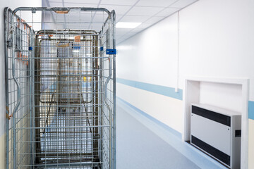 Shallow focus of typical logistic and transport crates which transport supplies for NHS hospitals in the UK. Seen within a hospital corridor after unloading.