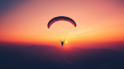 Paraglider Soaring through Vibrant Sunset Skies with Striking Colors Above Scenic Mountain Landscape in Evening Glow