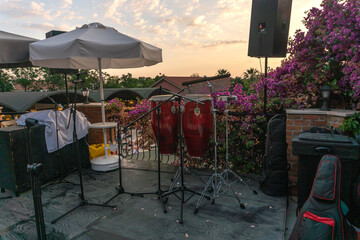 Evening at a southern resort. A musical performance is planned on stage. Musical instruments are...