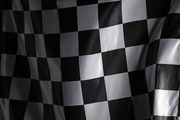 Racing checkered flag as background, closeup view