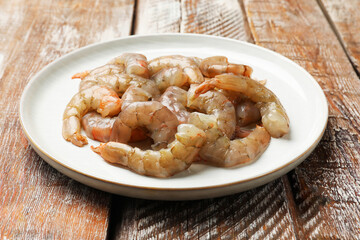 Fresh raw shrimps on wooden table, closeup