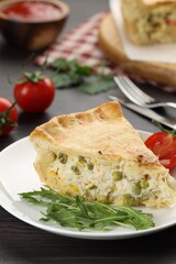 Piece of delicious fresh homemade pie served on wooden table, closeup