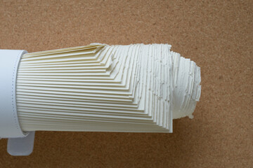paper object composed of a pile of staggered sheets on cork