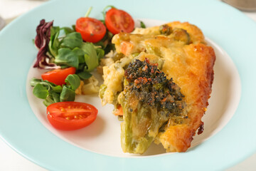 Tasty vegetable casserole and salad on white table, closeup