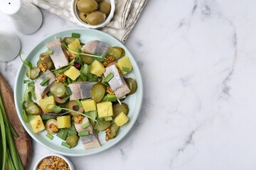 Delicious salad with herring and ingredients on white marble table, flat lay. Space for text