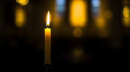 Burning Candle in Dimly Lit Scene: A lone candle burns brightly, its flame illuminating a shadowy space with an inviting ambiance, the focal point of this warm and inviting photo.