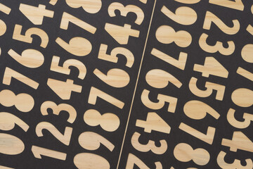 black paper machine-cut stencils with number cutouts on wood