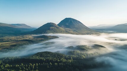 Aerial view of Glencoes rolling moors and mist-covered hills at sunrise, a perfect highland vista