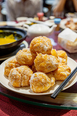 Traditional Cantonese fried egg puffs, also known as Sa Yung or Chinese doughnuts, crispy and golden, coated with sugar, popular dim sum dessert