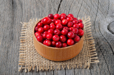 Ripe cowberry in wooden bowl