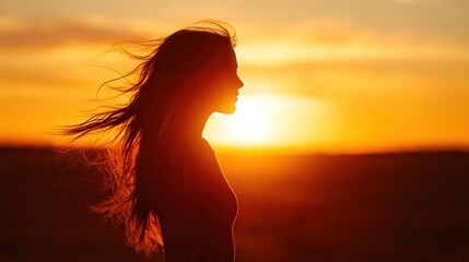 Silhouette of a Woman: Capturing the silhouette of a woman with flowing hair against the backdrop of a radiant sunset, evoking feelings of freedom and reflection. 