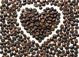 Close-up of roasted coffee beans arranged in a heart shape on a white background.