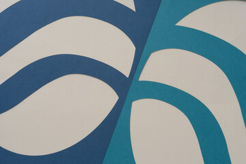 machine-cut paper shapes with curving stripes on beige