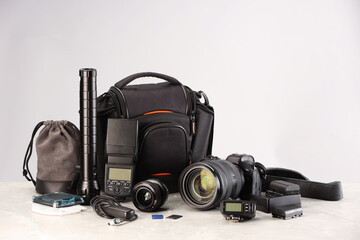 Professional photographer's equipment and case on light table. Space for text