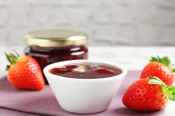 Delicious strawberry sauce and fresh berries on white table, closeup