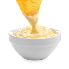 Dipping nacho chip into tasty cheese sauce on white background, closeup