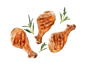 Grilled chicken legs or drumsticks falling down with herbs and colourful peppers isolated on white...