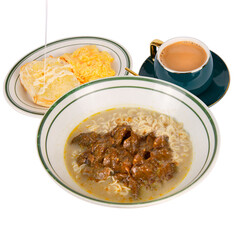 Hong Kong-style beef instant noodle set with scrambled eggs and buttered toast, served with classic milk tea, hearty and satisfying combo
