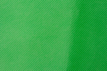 Green textured background creating a diagonal line dividing two different shades of green