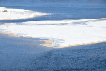 Zaporizhzhia, Ukraine, Khortytsia island. Dnipro river, snow-covered small islands among blue water, cold sunny day. 