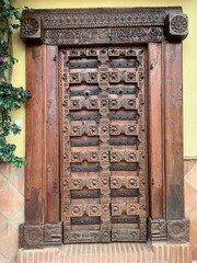 Carved wooden entrance doors as an architectural element in the Spanish city of Marbella