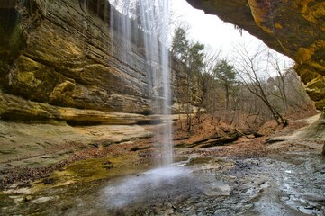 Early Spring landscape looking out from behind the LaSalle Canyon waterfall at Starved Rock State Park near Oglesby, Illinois.