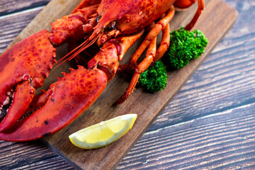 Red lobster on wooden cutting board 