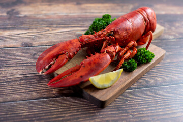 Red lobster on wooden cutting board 