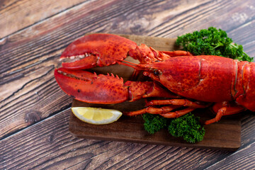 Red lobster on wooden cutting board 