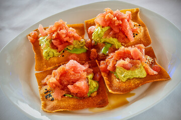 crispy fried won ton cups stuffed with fresh ahi tuna and a soy wasabi sauce