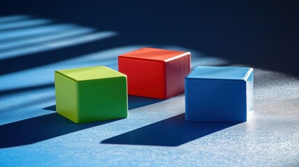 Obraz premium Three colored blocks are positioned on a textured blue surface