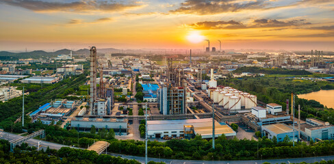 Fototapeta premium Oil refinery with industrial zone and colorful sky background at dusk