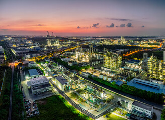 Aerial view of large oil refinery with dramatic sky at dusk