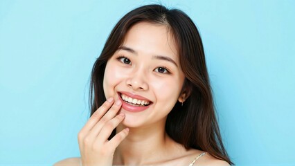 Fototapeta premium Smiling young woman showing off her sparkling white teeth - a captivating image of a confident expression and healthy smile, perfect for advertising teeth whitening products or dental care