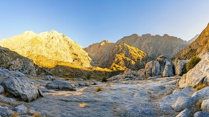 Obraz premium Sunrise Over Majestic Mountain Range, Golden Light Casts Long Shadows on Rugged Terrain, Captured with Wide-Angle Lens.