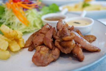 Delicious grilled chicken dish restaurant kitchen food warm lighting close-up view culinary delight