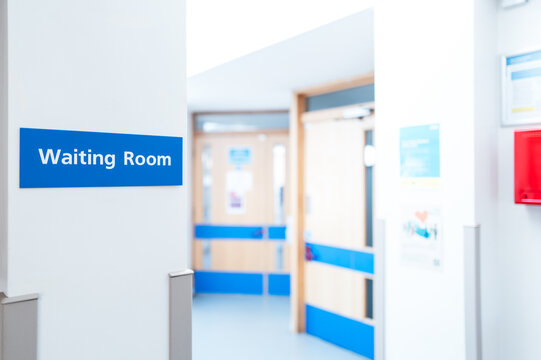 Typical British hospital and GP waiting room sign seen within a patient's medical waiting area. The corridors lead to various medical units.