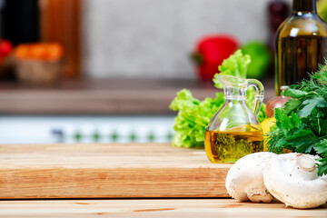 Healthy vegan eating, cooking, food blogging banner background with cutting board with lettuce, wine bottle, mushrooms and other vegetables and herbs on cozy kitchen with wooden table, kitchenware 