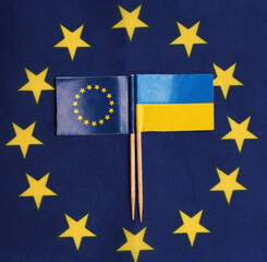 ukraine and eu flags against the background of the eu flag. Concepts of the desire to join the eu of ukraine