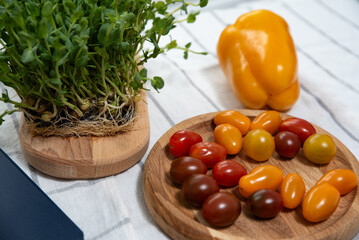 technology in the kitchen: vegetables and greens are on the table next to the tablet