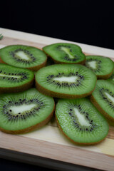 Kiwi organic fruit. Kiwi on wooden background.  Fresh ripe juicy kiwi. Whole fruit and slices...