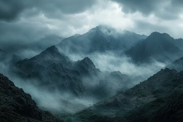 Dark mountains shrouded in mist during overcast weather