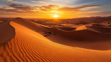 The stunning sand dunes of the Sahara Desert in Merzouga, Morocco, are bathed in the golden light of a magnificent sunrise, showcasing the striking beauty of Moroccoâ€™s vast desert landscape