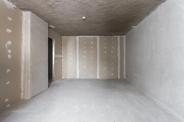 interior of the apartment without decoration in gray colors. rough finish