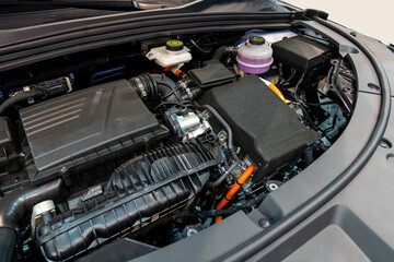 Hybryd car with open hood. Close up of inverter and engine