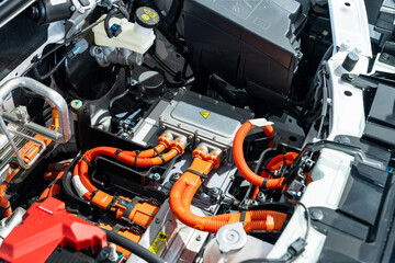 Electric car with open hood. Close up of inverter and wires.