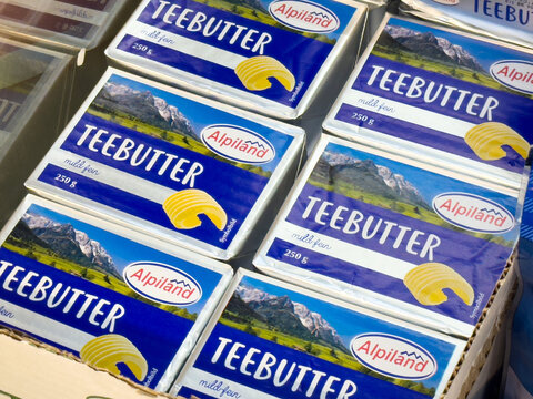 Alpiland teebutter packaging with scenic mountain design in grocery display